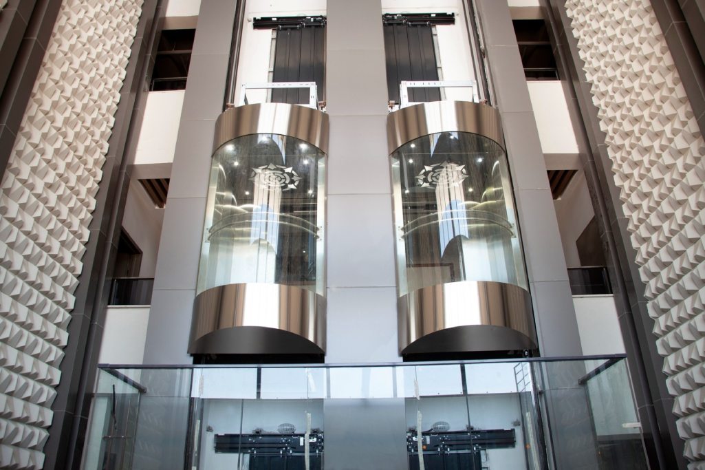 A modern, well-lit elevator interior after modernization